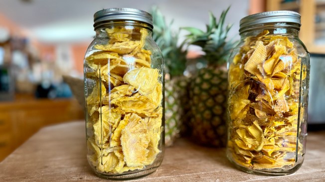 Image shows dried pineapple in mason jars
